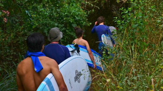 Group walking the jungle trail toward Playa La Lancha for a surf lesson