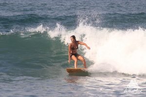 Woman surfing waves in the Pacific