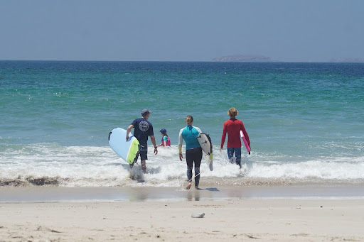 Family enjoying surf lessons at one of the best family surf camps