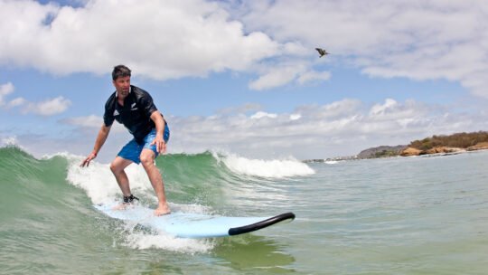 Surfer riding a wave at La Lancha beach