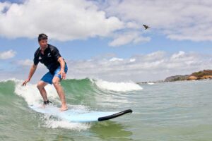 Surfer catching a wave at La Lancha beach during WildMex photo session