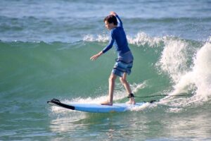 Focused boy surfing a wave during WildMex surf photography session