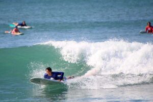 Surfer preparing to catch a wave during WildMex surf photo session