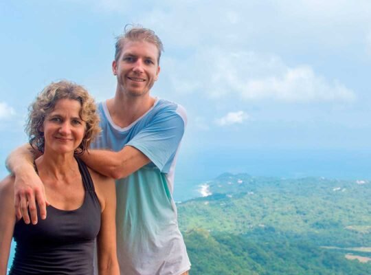 Couple posing with panoramic view from Monkey Mountain summit