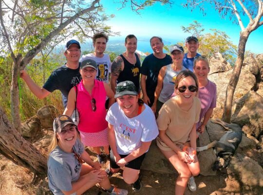 Happy family posing at Monkey Mountain summit during WildMex hike