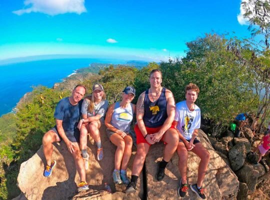 Family posing with scenic view from Monkey Mountain during WildMex tour