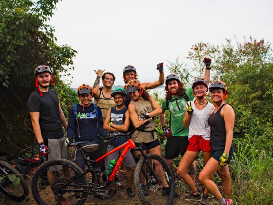 Group of mountain bikers posing in jungle setting during Sayulita tour