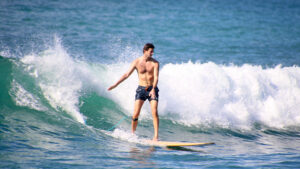 Surfer riding a wave in Punta Mita, fully focused on the experience