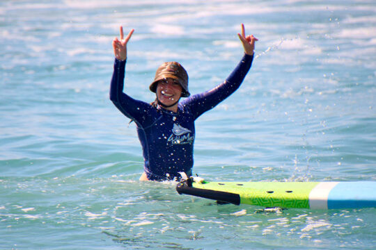 Group of friends taking a surfing in San Pancho lesson.